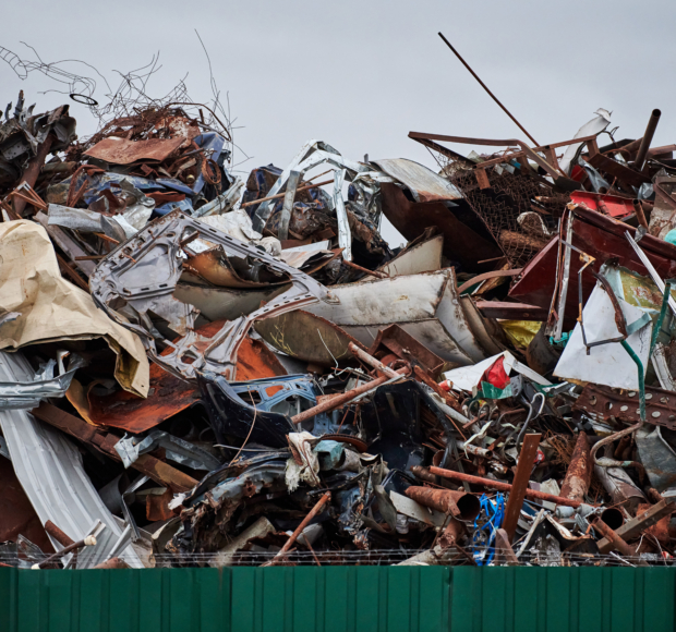 Metal scrap waste dump for recycling. City fenced landfill. Iron garbage and trash.